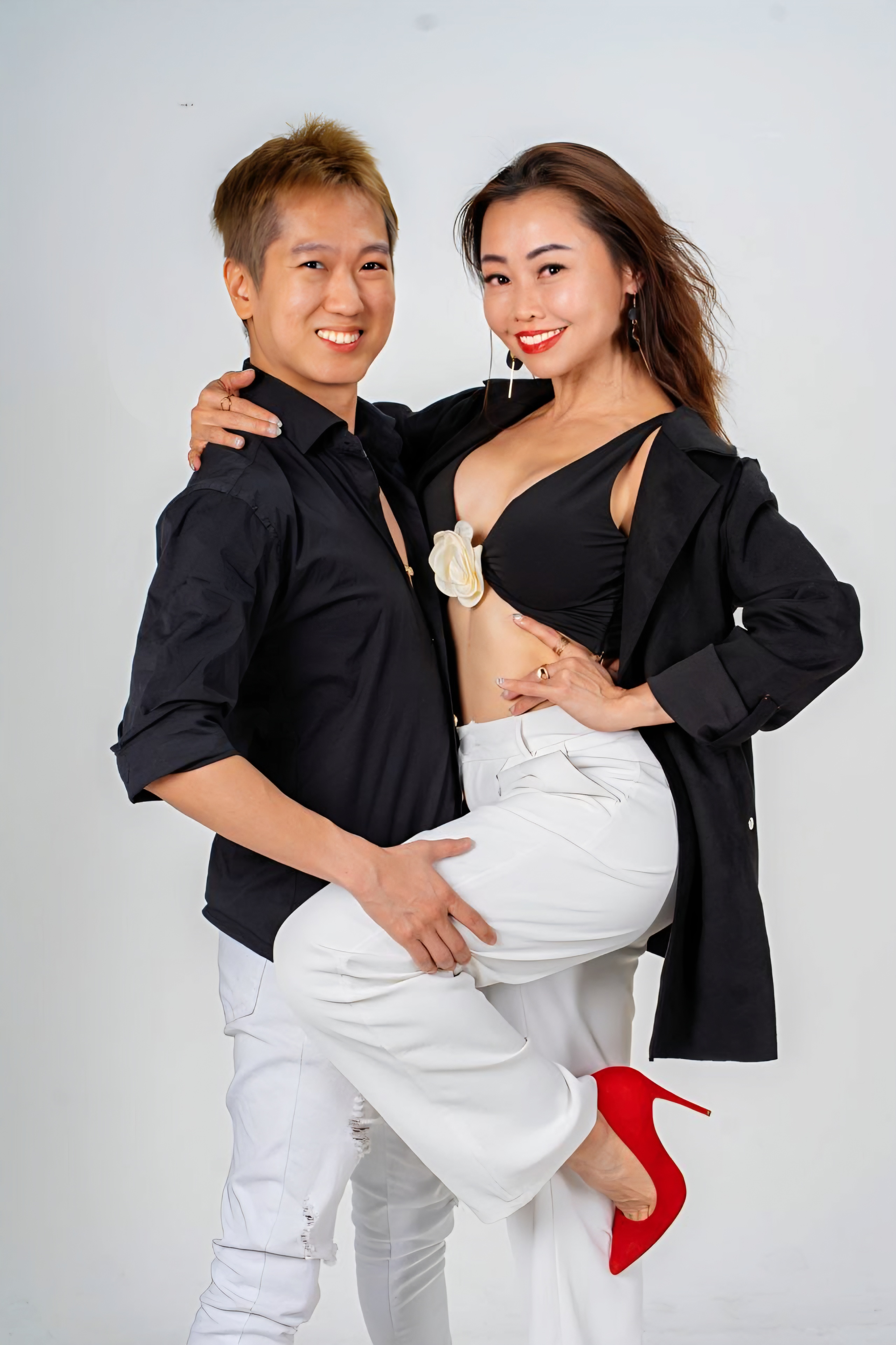 Nick and Vivi posing together in studio attire